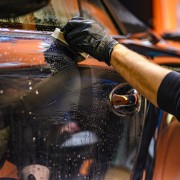 A picture of a car being washed