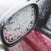 An image of a wing mirror covered in snow